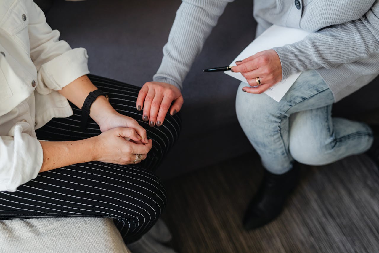 A supportive moment during a counseling session, featuring attentive listening and comfort.